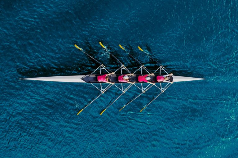 overview of a rowing team on the water