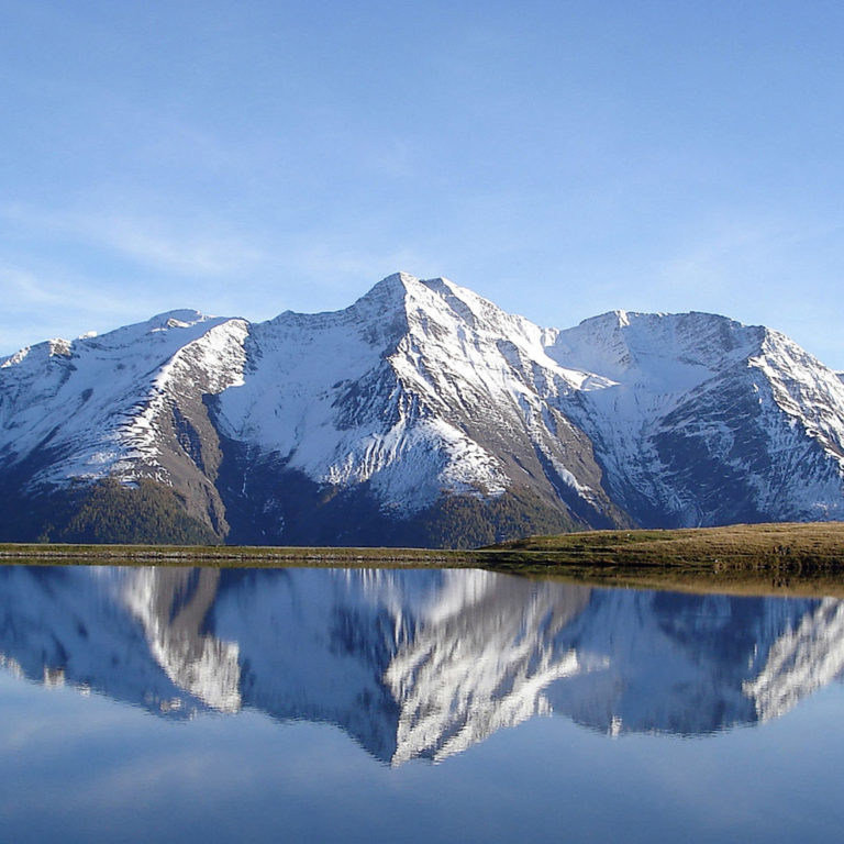 mountain range reflecting onto water