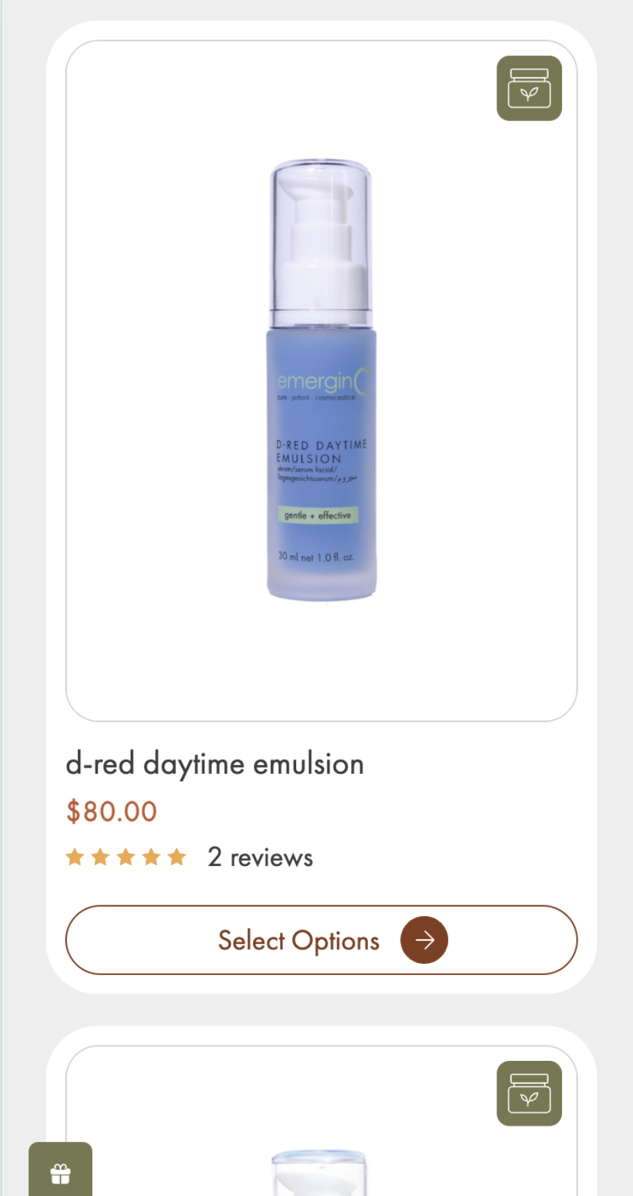 A blue bottle of emerginC d-red daytime emulsion, 30 ml, priced at $80.00 with 2 reviews and a 5-star rating, elegantly displayed on a skincare website design product selection page.