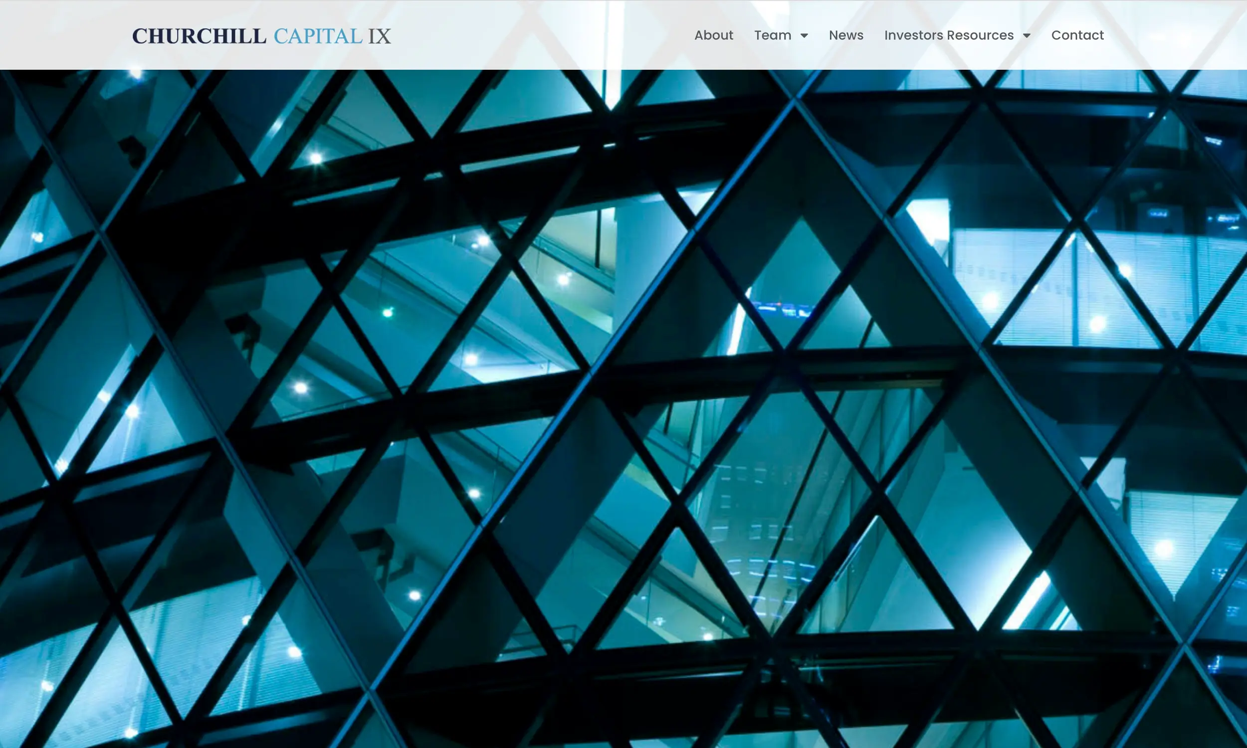 Glass exterior of a modern building with geometric patterns and illuminated interior floors at night, reflecting the sophistication often seen in investment company website design on the Churchill Capital IX homepage.