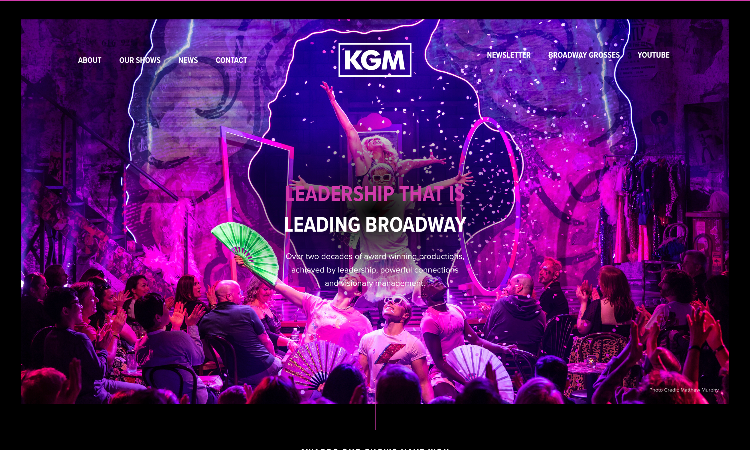 A performer on stage before an audience with fans, under vibrant purple lighting, with "Leadership That is Leading Broadway" and the KGM logo—perfect inspiration for innovative theater website design.