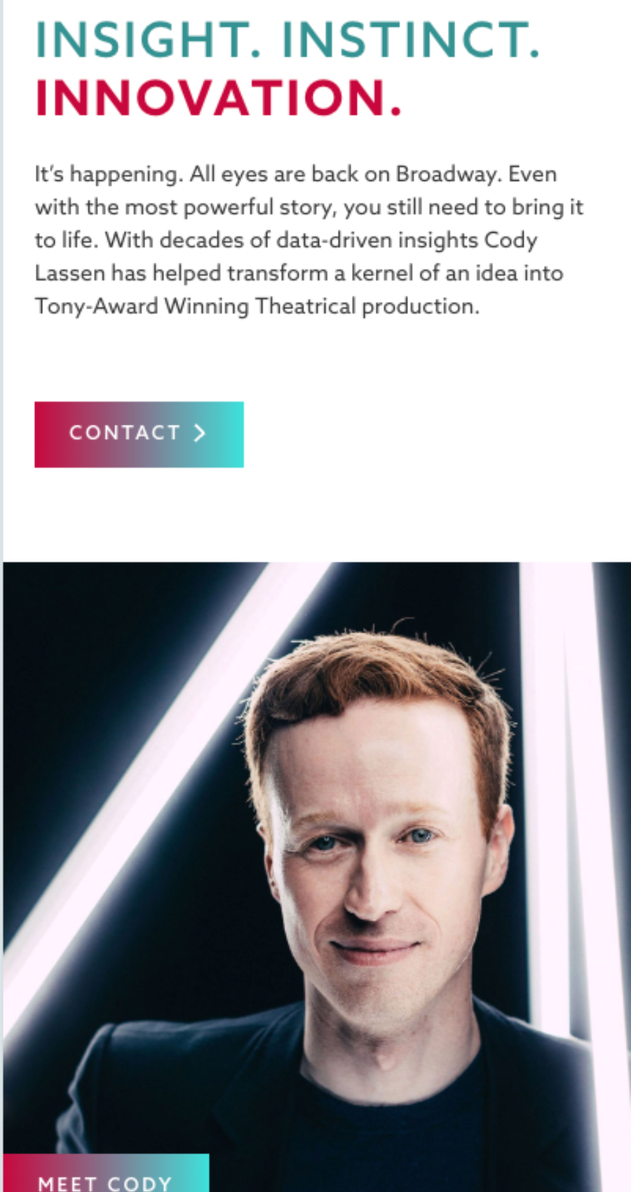 A man with short hair and glasses stands in front of a black background with white diagonal light beams behind him, creating a dynamic look reminiscent of modern entertainment website design.