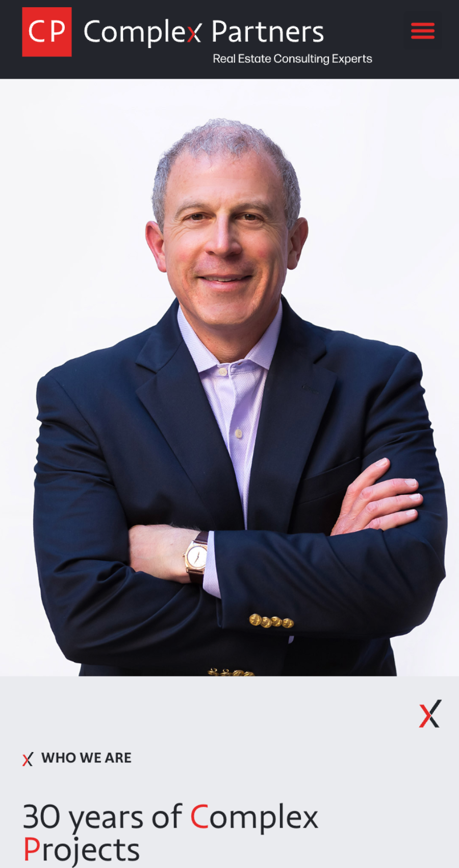 A man in a navy blazer stands with arms crossed, smiling in front of a white background; "Complex Partners" real estate consulting website branding is visible above him.