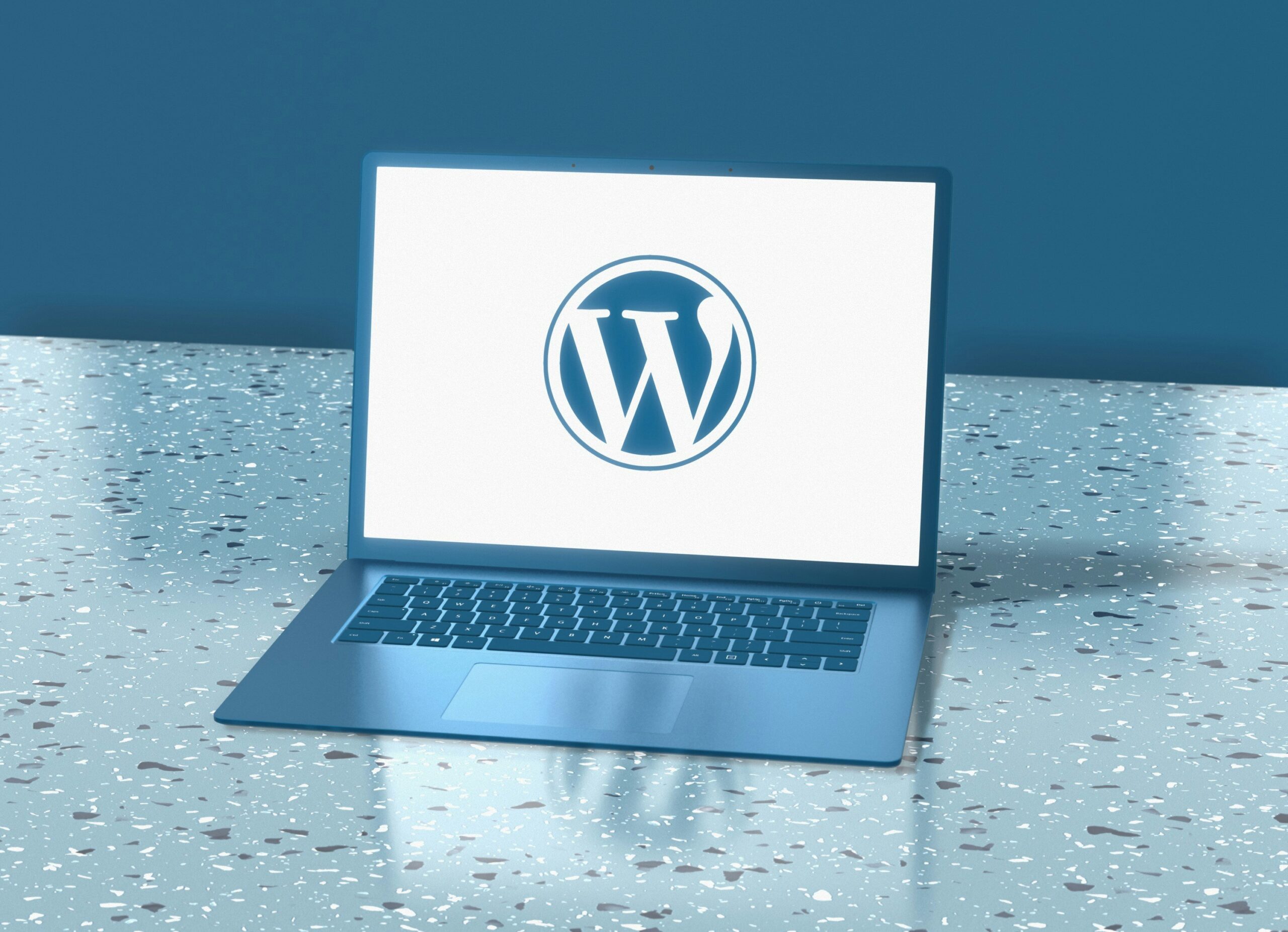 WordPress logo on a laptop home screen